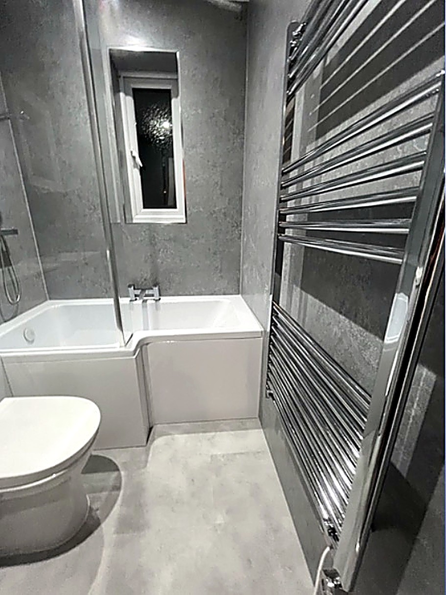 Bathroom with chrome heated towel rail
