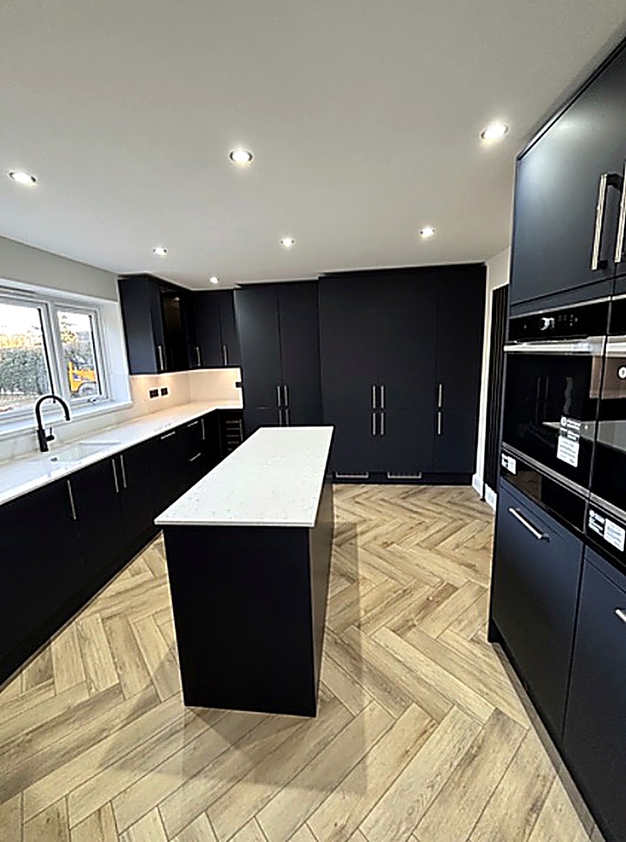 Matte navy kitchen with herringbone flooring