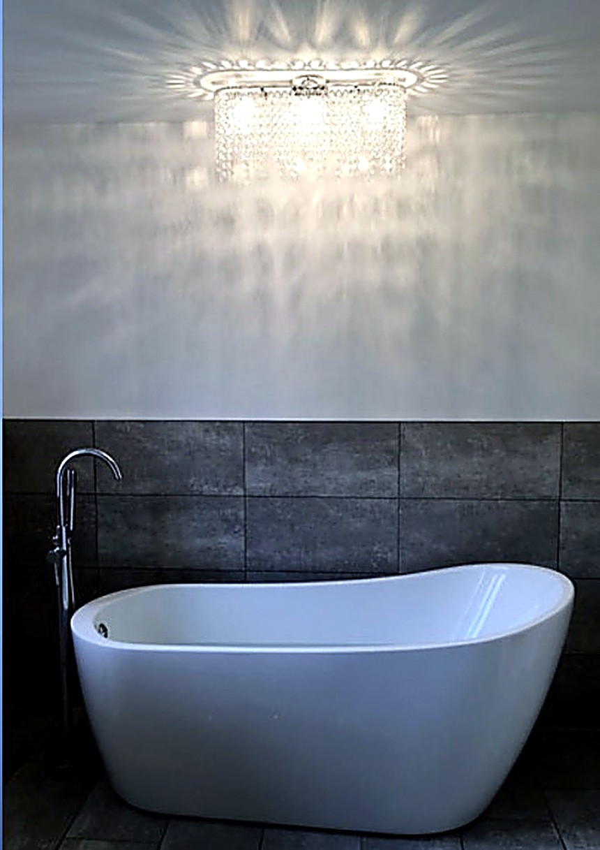 Freestanding bath with statement lighting